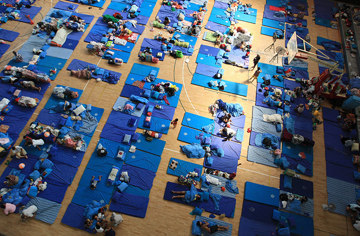 24 hours in pictures: Thai flood refugees rest inside the evacuation centre, Bangkok, Thailand