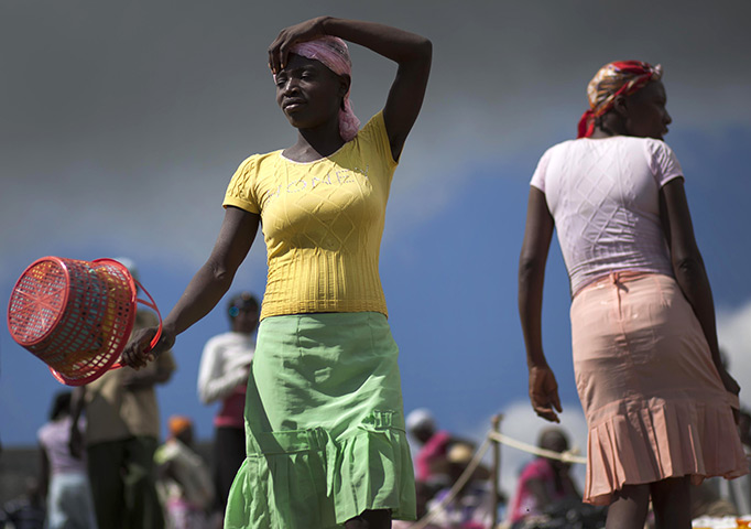 24 hours in pictures: A woman shops for food in the market in Cornillon, Haiti