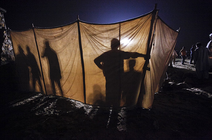 24 hours in pictures: Paramilitary forces construct a barrier around scene of a blast in Karachi