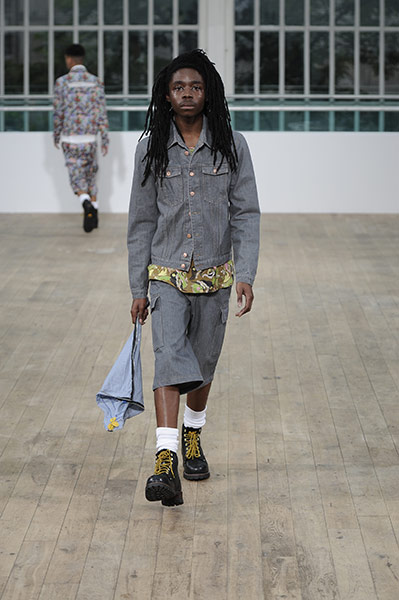 Skateboarding Fashion: man in denim shorts suit and camouflage t-shirt