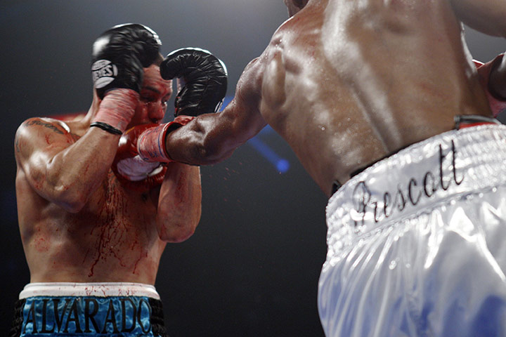 Sport pics of the week: Mike Alvarado of the U.S. takes a punch from Breidis Prescott 
