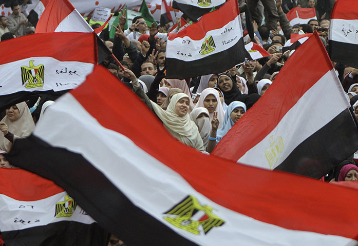 protests in cairo: Women wave flags in Tahrir