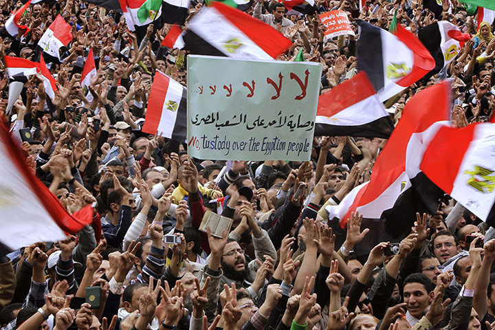 protests in cairo: Protesters wave placards and flags