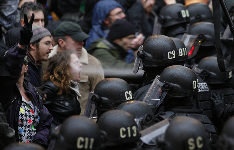 Occupy Day of Action: A police officer uses pepper spray on an Occupy Portland protester