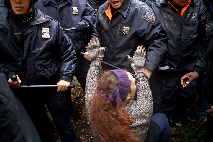 Occupy Day of Action: A woman puts her hands during a fight between police, Zuccotti Park