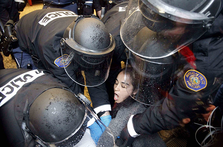Occupy Day of Action: A Occupy Portland protester is arrested at Wells Fargo bank