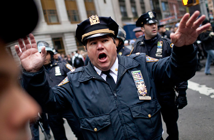 Occupy, Day of Action: A police officer demands protesters to move in the Financial District 