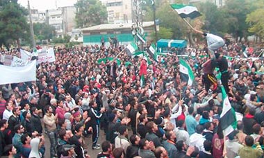 Syrian demonstrators protest against Bashar al-Assad after Friday prayers in Homs