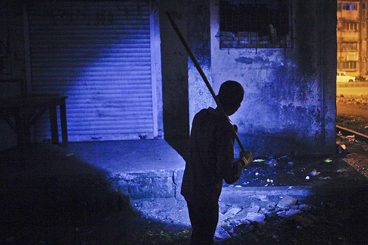 24 hours: a boy searches for rats outside a residential complex in Mumbai
