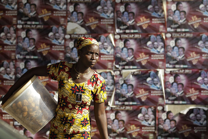 24 hours: A food seller in an underpass hawks her wares in Benin, Africa