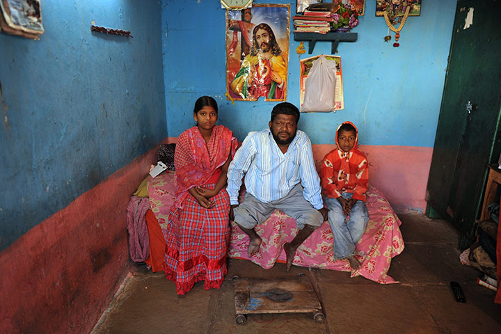 24 hours: Indian disabled man Narising Rao, poses with with his children 