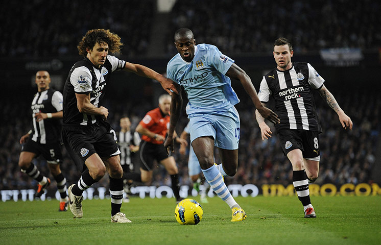 Man City v Newcastle: Yaya Toure goes past Fabricio Coloccini