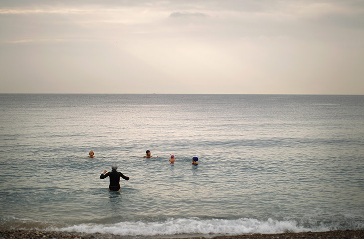 24 hours in pictures: Women take an early morning swim at Opera Beach in Nice