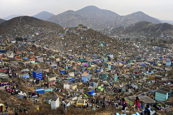 All saints day: Musicians and a ballon vendor walk in the Nueva Esperanza cementery, Lima