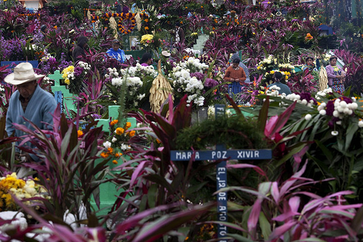 All saints day: Family members decorate the graves of a departed relatives, Guatemala