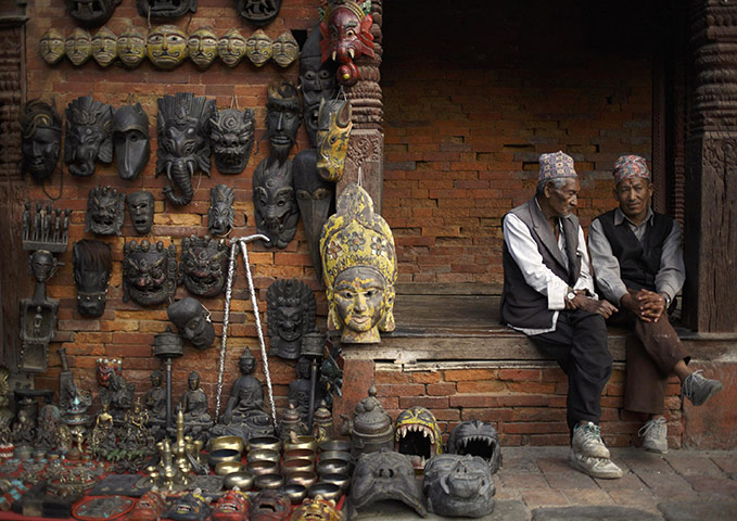 FTA: Navesh Chitrakar: Men sit and chat to pass their time near a shop selling masks in Kathmandu