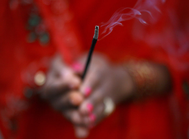 FTA: Navesh Chitrakar: A devotee holds an incense stick during the Chhat festival in Kathmandu 