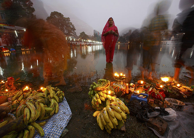 FTA: Navesh Chitrakar: A worshipper waits for sunrise to offer prayers during the Chhat festival 