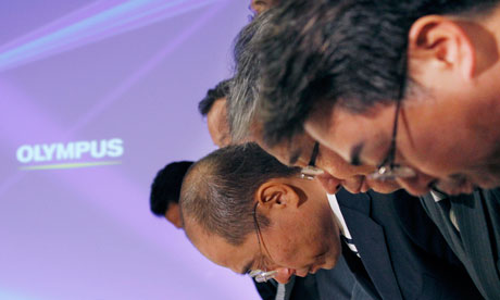 Olympus executives bow after a press conference in Tokyo