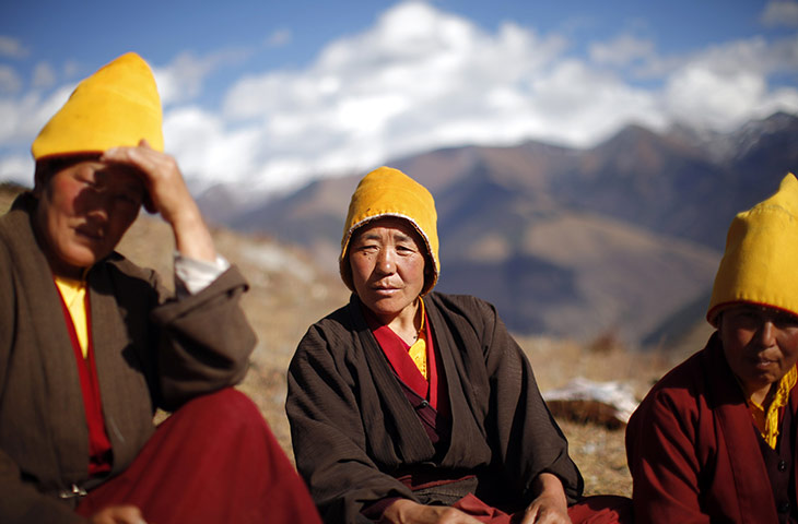 24 hours in pictures: Tibetan Buddhist nuns sit on a mountain slope, China
