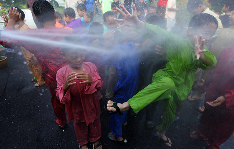 24 hours in pictures: Boys are hosed down before a mass circumcision ceremony in Kajang 