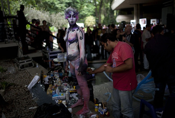 24 hours in pictures: Artist paints the body of a woman at World Meeting of Body Art, Venezuela 