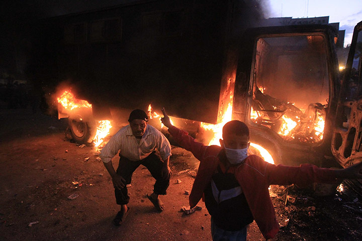 24 hours in pictures: An Egyptian police vehicle burns as protesters clash at Tahrir Square