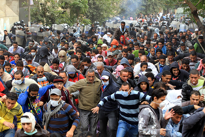Cairo protests: Egyptians protesters are pushed away by security forces in Cairo
