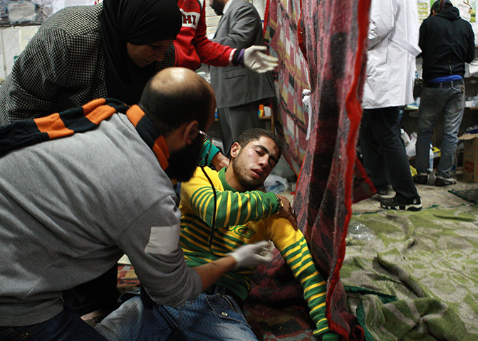 Cairo protests: A wounded Egyptian protester is examined by a doctor at makeshift hospital