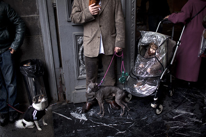 24 hours in pictures: Madrid, Spain: People stand outside a polling station 