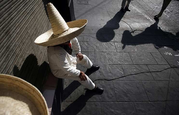 24 hours in pictures: Mexico City, Mexico: A soldier wearing traditional revolutionary costume