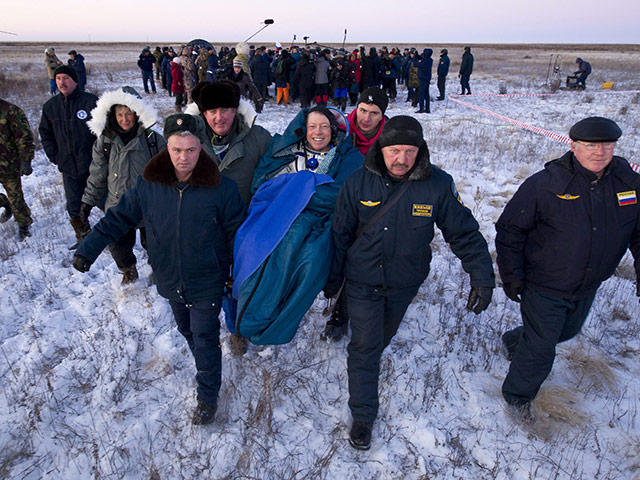 Soyuz landing Kazakhstan : Commander Mike Fossum is carried in a chair to the medical tent