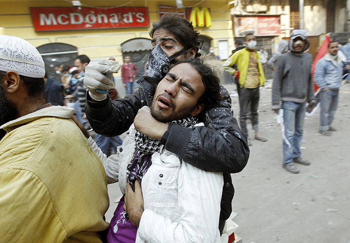 Egypt protests day 4: An injured protester is transported by motorbike 