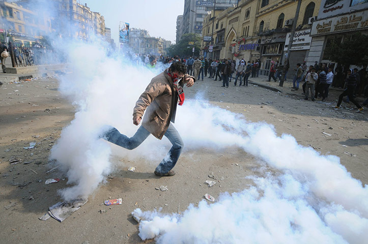 Egypt protests day 4: An Egyptian man dodges tear gas during clashes