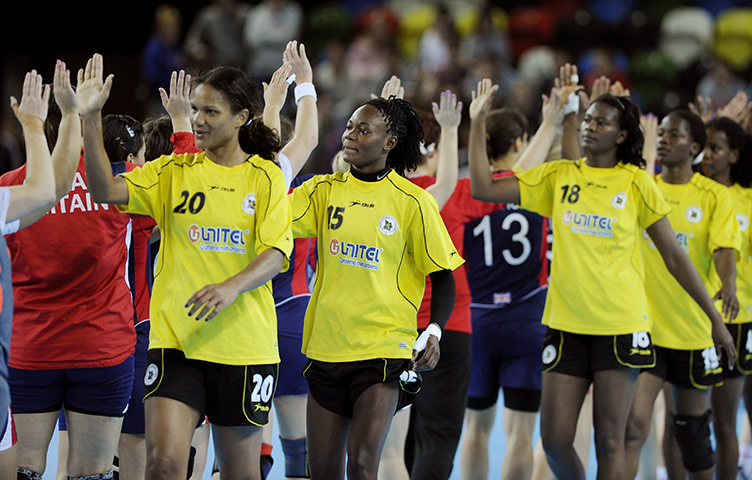 Handball: GB and Angola handball teams high-five at the end of the game