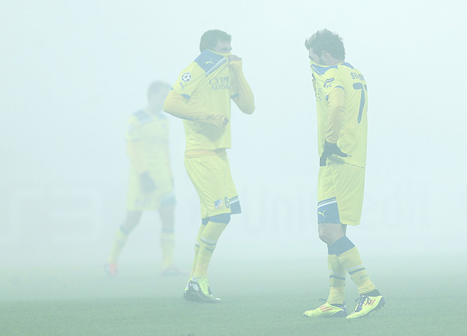 24 hours in pictures: Smoke from flares blankets the pitch as Apoel players react, St. Petersburg