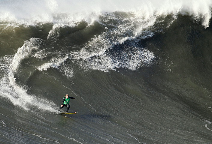 best of the week in sport: Andrew Cotton rides a wave at a tow-in surf competition Portugal