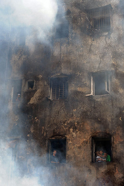 24 hours: Mumbai residents watch firefighting operations after a fire in the vicinity