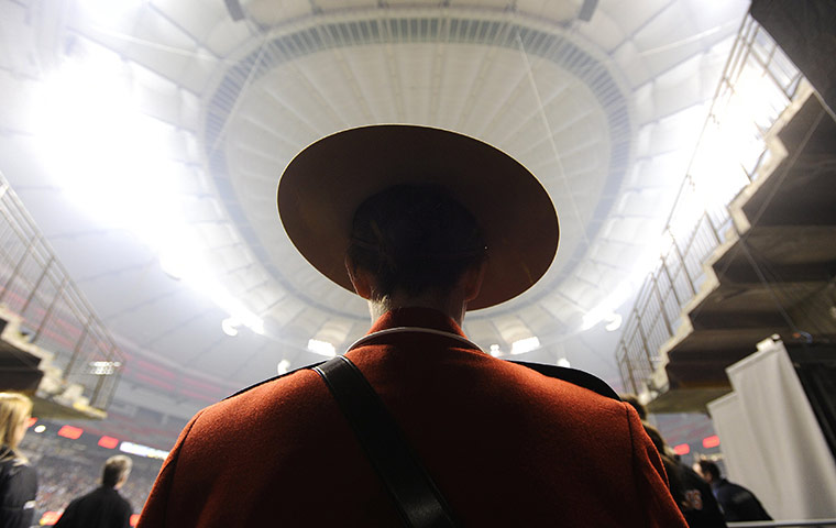 24 hours: Canadian Mounted Police officer waits to present the Vanier Cup trophy