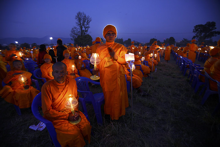 24 hours in pictures: Kathmandu, Nepal: Monks with candles at the Together for World Peace event 