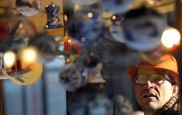 24 hours in pictures: Strasbourg, France: A man looks at Christmas decorations