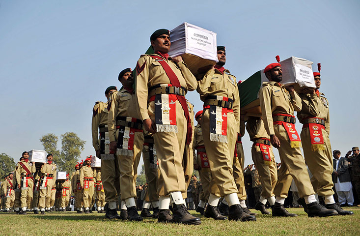 Pakistan NATO raids: Pakistani soldiers carry the coffins of their comrades 
