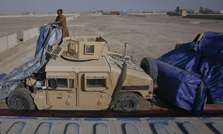 Pakistan NATO raids: A truck driver covers a humvee, headed for NATO troops
