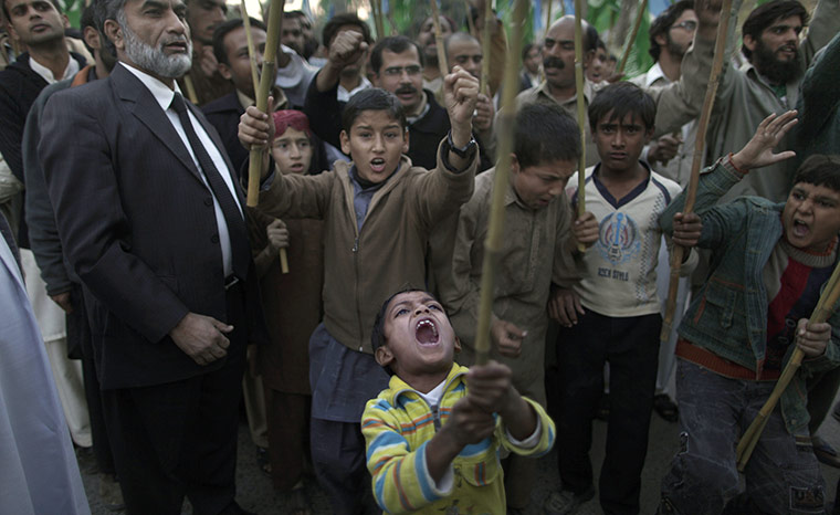 Pakistan NATO raids: A Pakistani boy shouts slogans along with other protesters during a rally