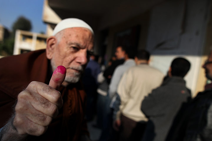 Egypt elections: An elderly Egyptian man shows his ink-stained thumb 