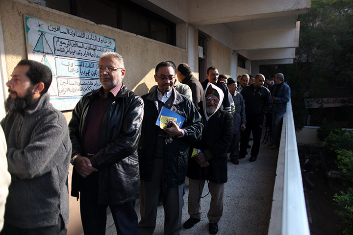 Egypt elections: Egyptian voters queue outside a polling station in the Manial neighbourhood