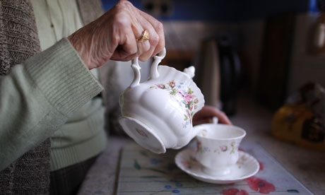 elderly woman pours tea