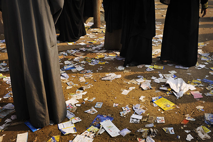 Elections in Egypt: Voters stand on election leaflets before entering a polling station