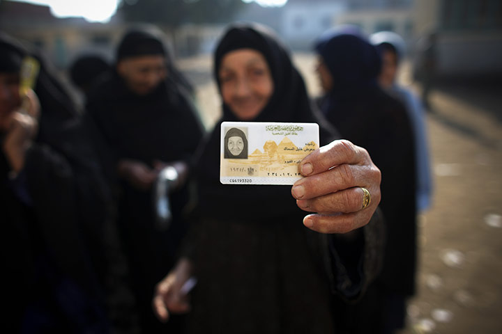 Elections in Egypt: A woman shows her identification card as she waits to vote