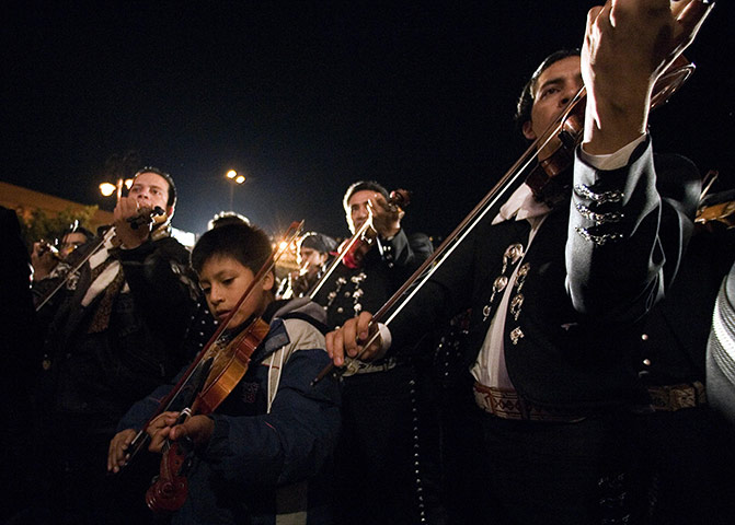 Intangible heritage: A young Mariachi plays his violin during a serenade in Mexico City